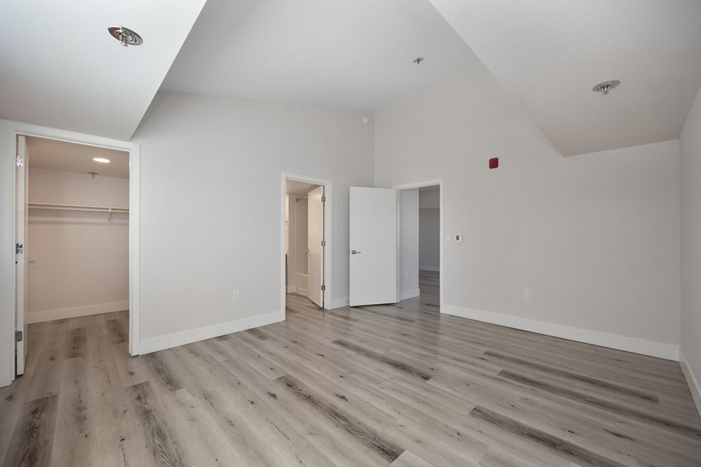 a renovated living room with white walls and wood floors  at Track 281 Apartments, Sacramento, 95811