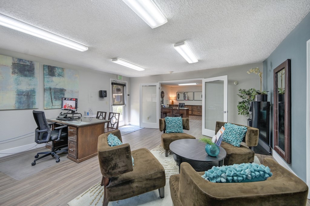 Asbury Place Apartments leasing office with lounge chairs and management desks 