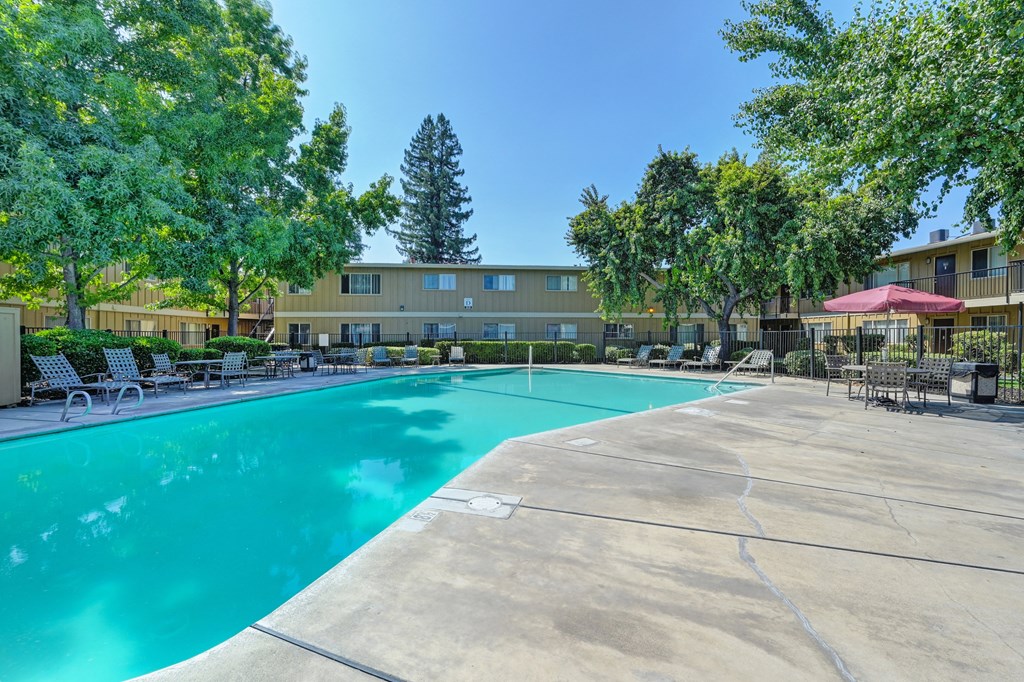 Asbury Place Apartments swimming pool area with lounge seating. 