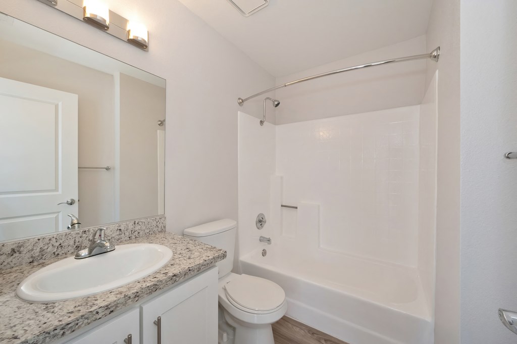 a bathroom with a sink toilet and bathtub