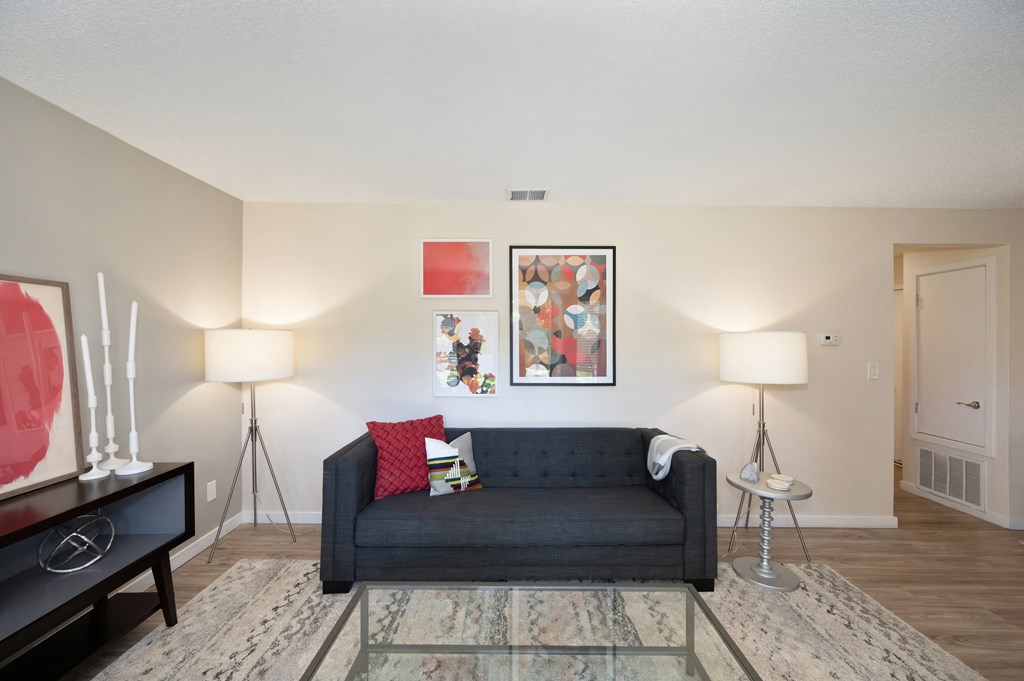 a living room at West Oaks with a couch and a rug