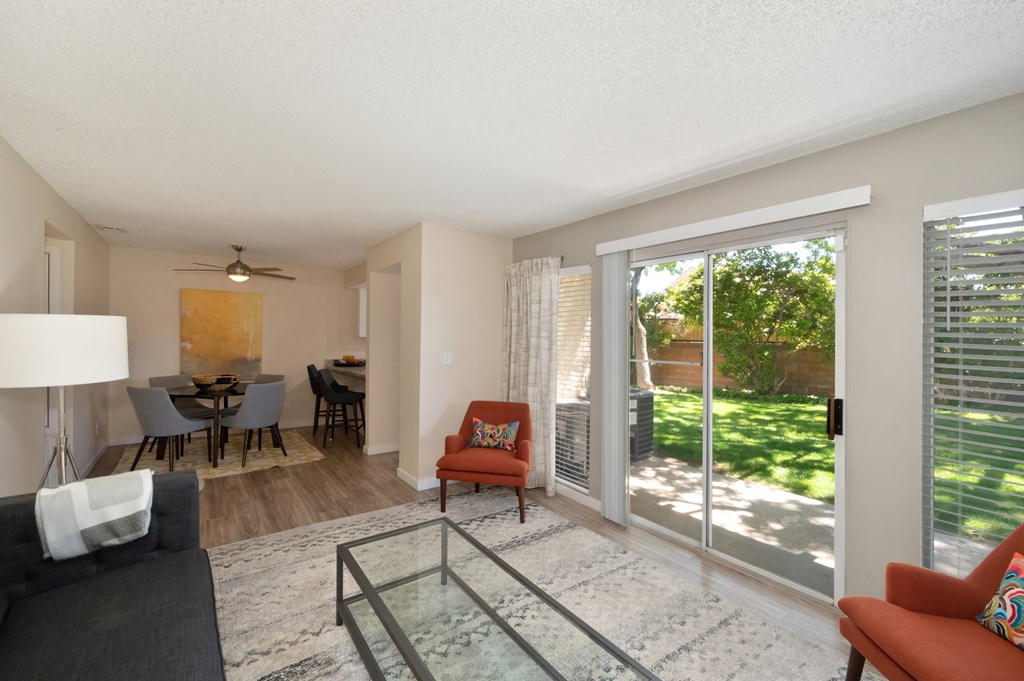 an open living room and dining room with sliding glass doors to a patio