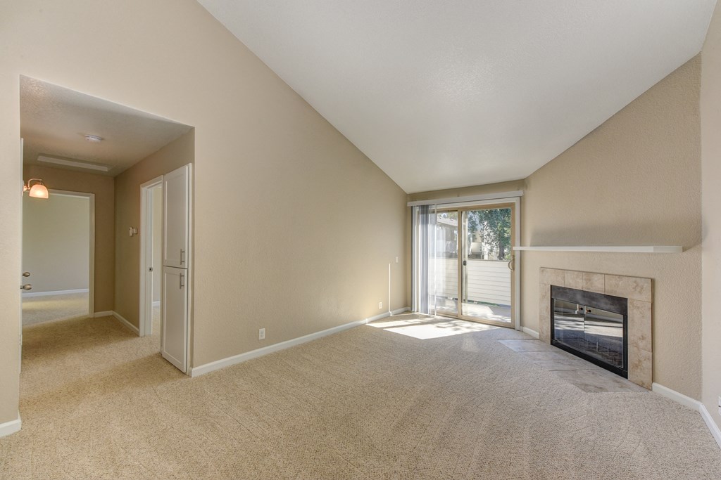 2 bedroom home upstairs with wood burning fireplace,  views of the outdoor patio and down the long hallway to the bedrooms.at Cobblestone Creek Apartments, Roseville, 95661