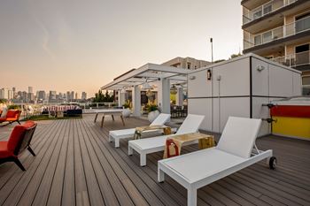 A wooden deck with white chairs  at The Summit at Lake Union, Seattle, Washington