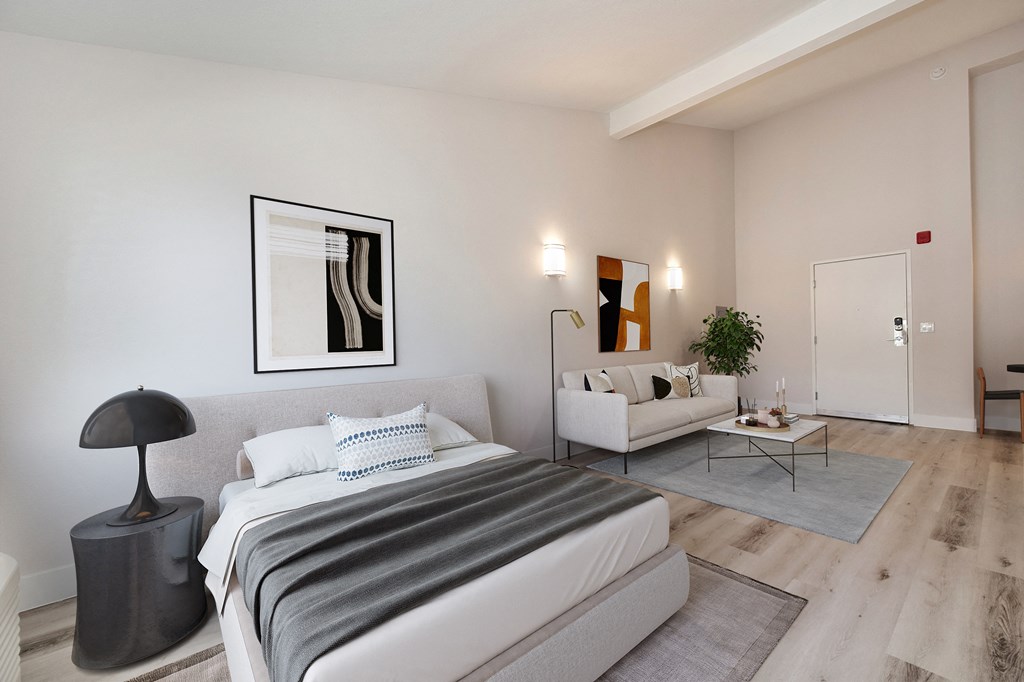 a bedroom with a bed and a couch and a living room  at Track 281 Apartments, Sacramento, CA