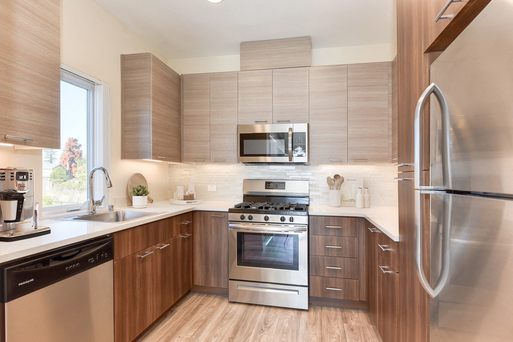 a kitchen with stainless steel appliances and wooden cabinets