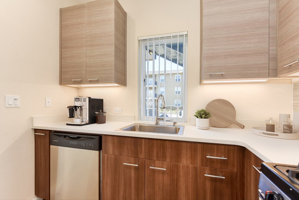 a kitchen with wooden cabinets and a sink and a window