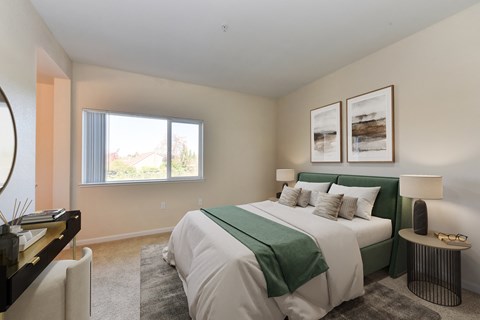 a bedroom with a large bed and a window  at Addison Ranch Apartments, Petaluma, CA