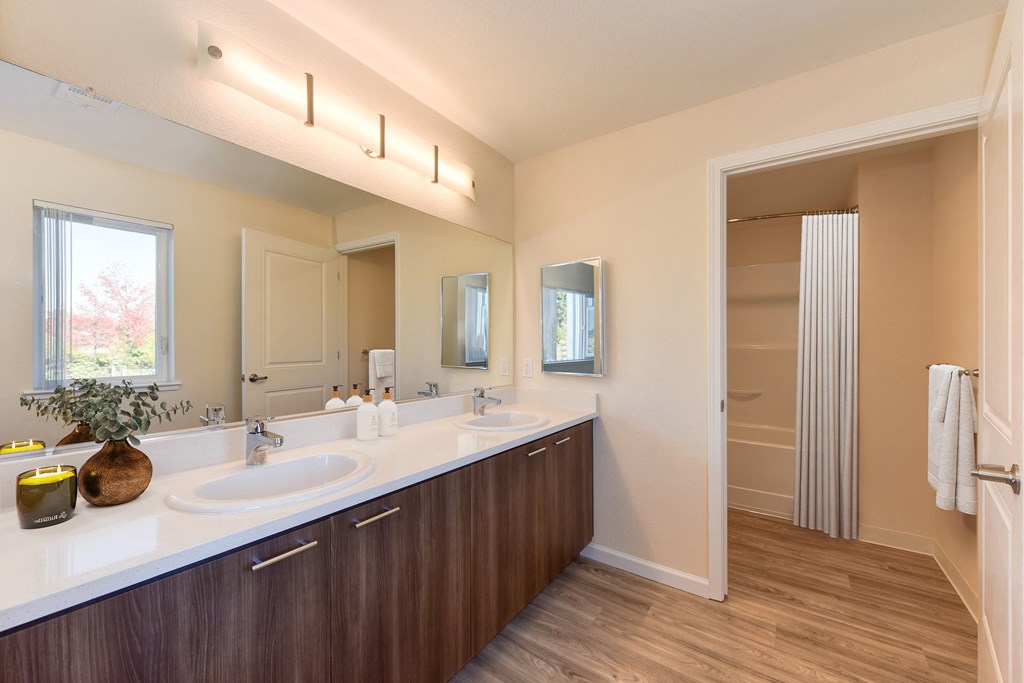 a bathroom with two sinks and a large mirror