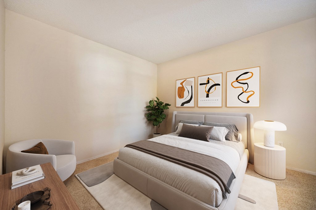 a bedroom with a bed, a chair, dresser and decorative plant 