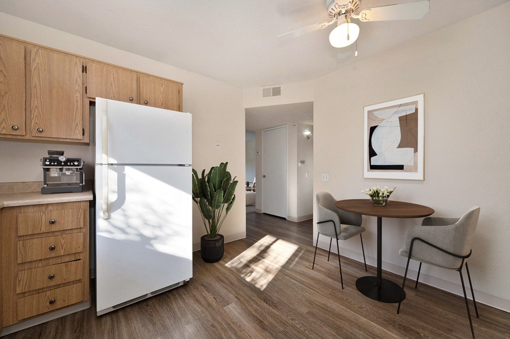 a kitchen and dining room with a refrigerator and a table