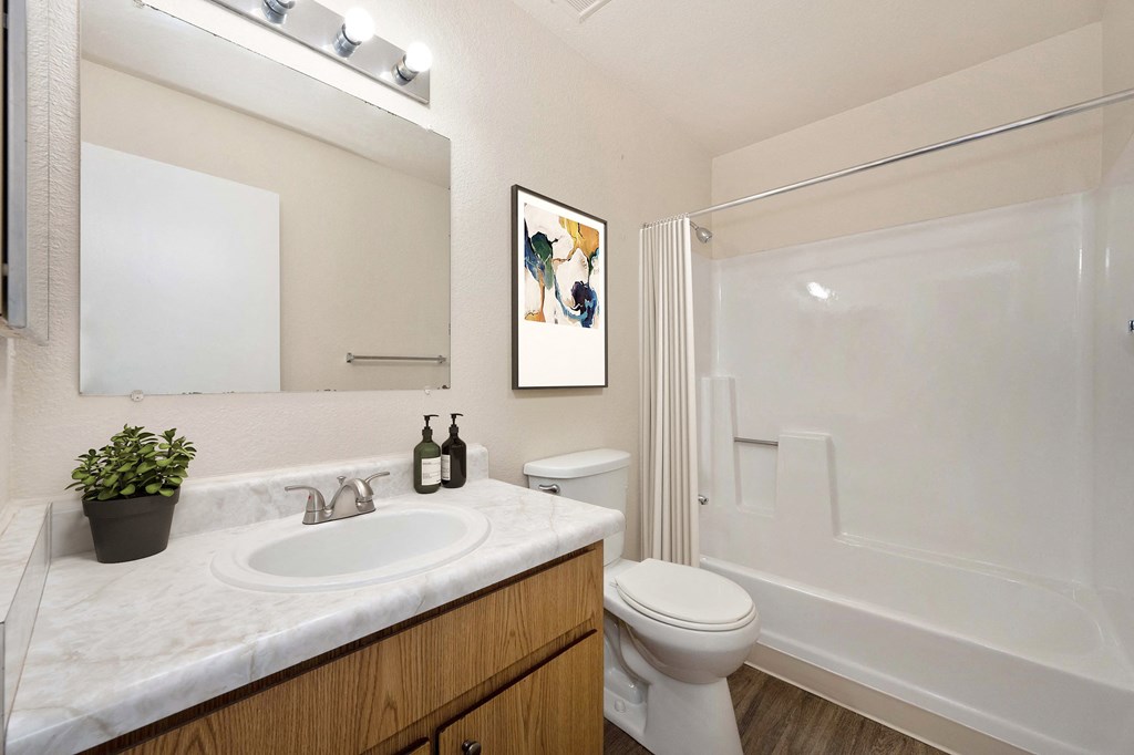a 2 bedroom, 2 bath floor plan bathroom with sink & vanity and tub/shower enclosure. 