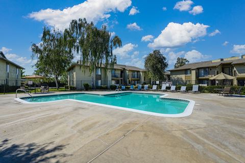 Breckenridge Village swimming pool with lounge chairs and umbrellas in front of a building