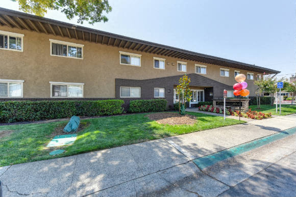 Building Entrance with Grass, Walkways and Tree  at Olympus Park Apartments, Roseville, CA