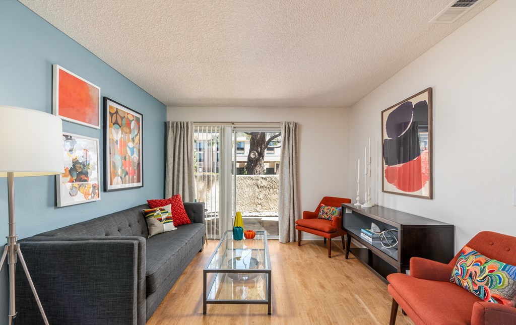 a living room with a couch and a television and a glass coffee table