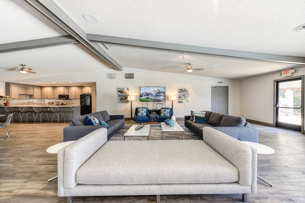 Community Clubhouse with Large Cushioned Bench Seating and More Couches in Distance at The Renaissance Apartments, Citrus Heights, 95610