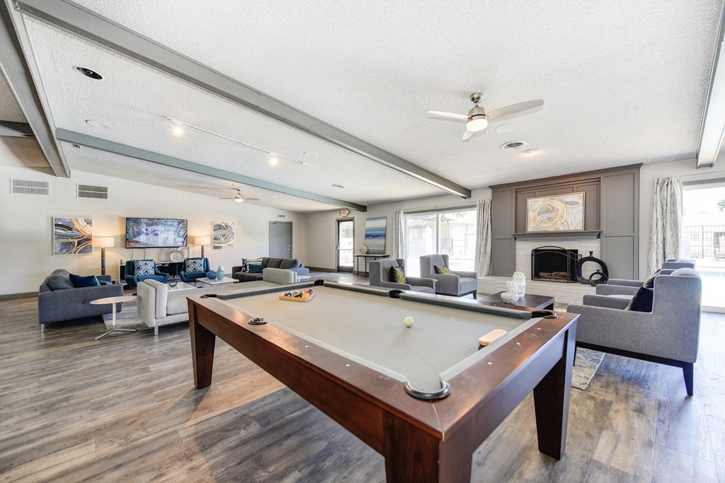 Clubhouse Sitting Area with Pool Table, Hardwood Inspired Floor, Gray and White Sofas at The Renaissance Apartments, Citrus Heights, CA