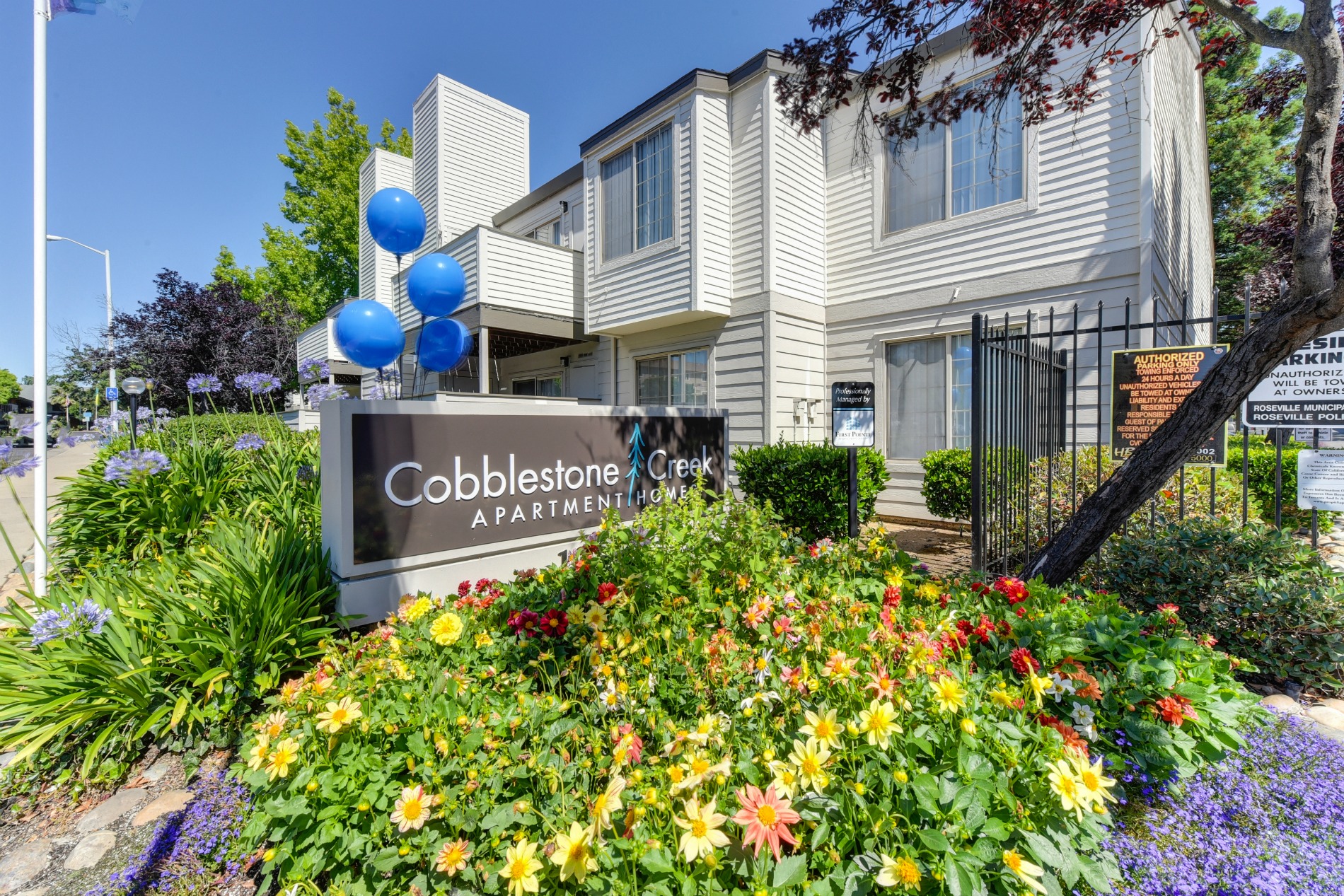 Cobblestone Creek Monument  Sign at Entrance with Flowerbed and aPARTMENT eXTERIORS at Cobblestone Creek Apartments, Roseville, 95661