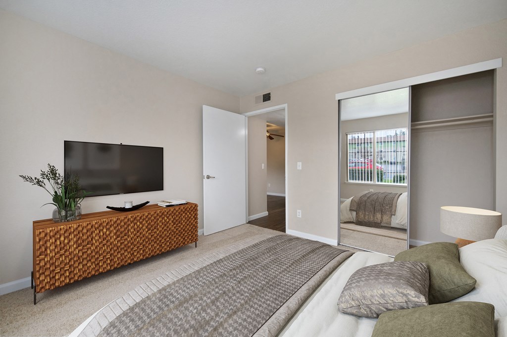 a bedroom with a large bed and a tv