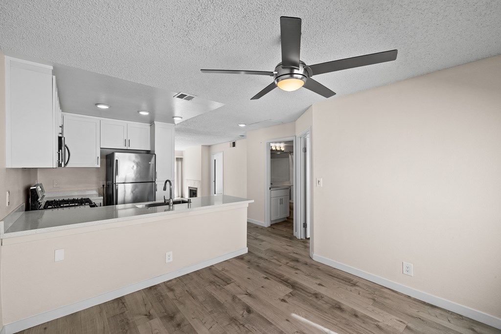 A kitchen with a fan on the ceiling.