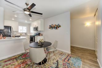 Dining Room Dining Room with Rug, Hardwood Inspired Floor, Ceiling Fan/Light and Round Black Table - Photo Gallery