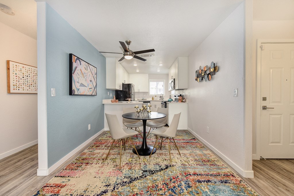 Dining Area with Hallway, Table, Rugs and Ceiling Fan/Light at The Legacy Apartments, Antelope, California