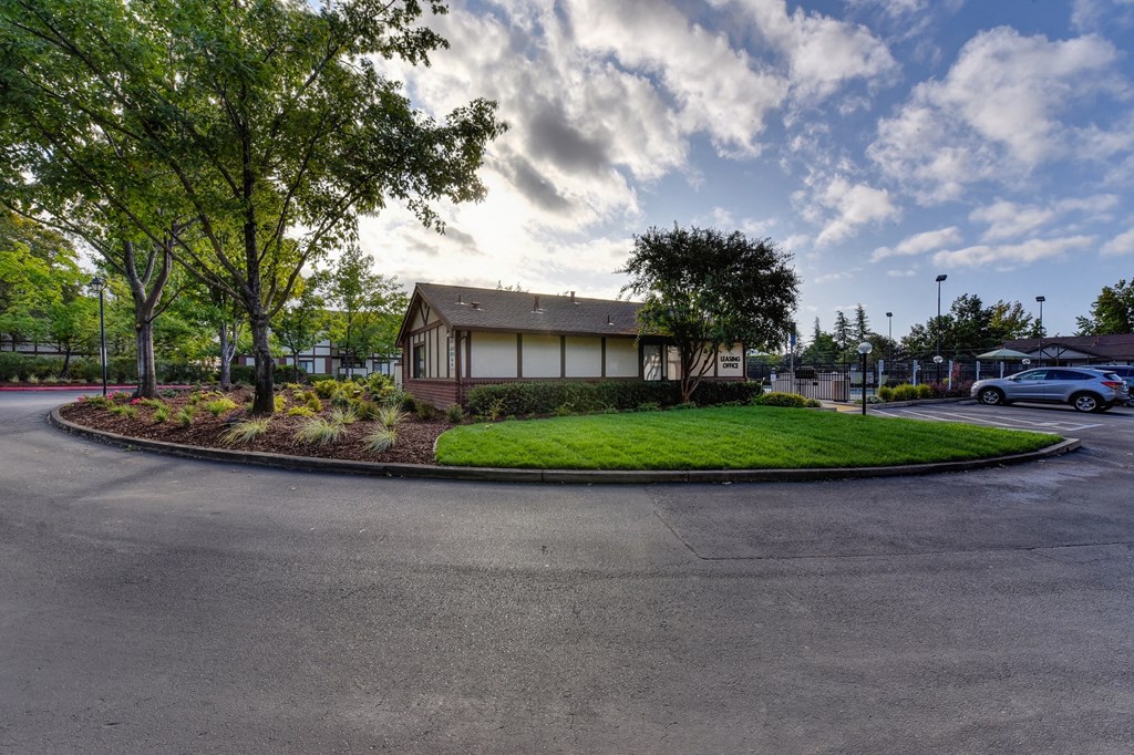 Entrance Road with Road, Grass, Trees and Building Exterior at Rocklin Manor  Apartments, Rocklin