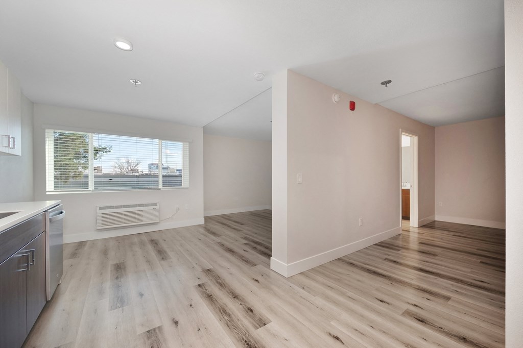 an empty kitchen and living room with wood flooring and a window  at Track 281 Apartments, Sacramento, CA, 95811