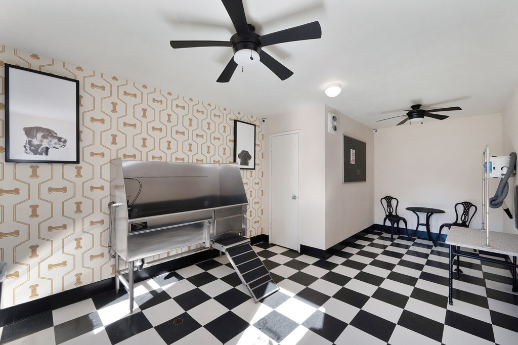 A black and white checkered floor in a room with a fan.
