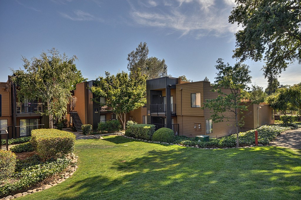 Community Outdoor Green Space with Grass, Trees, Apartment Building Exteriors and blue skies.at Fountains of Fair Oaks, California, 95628