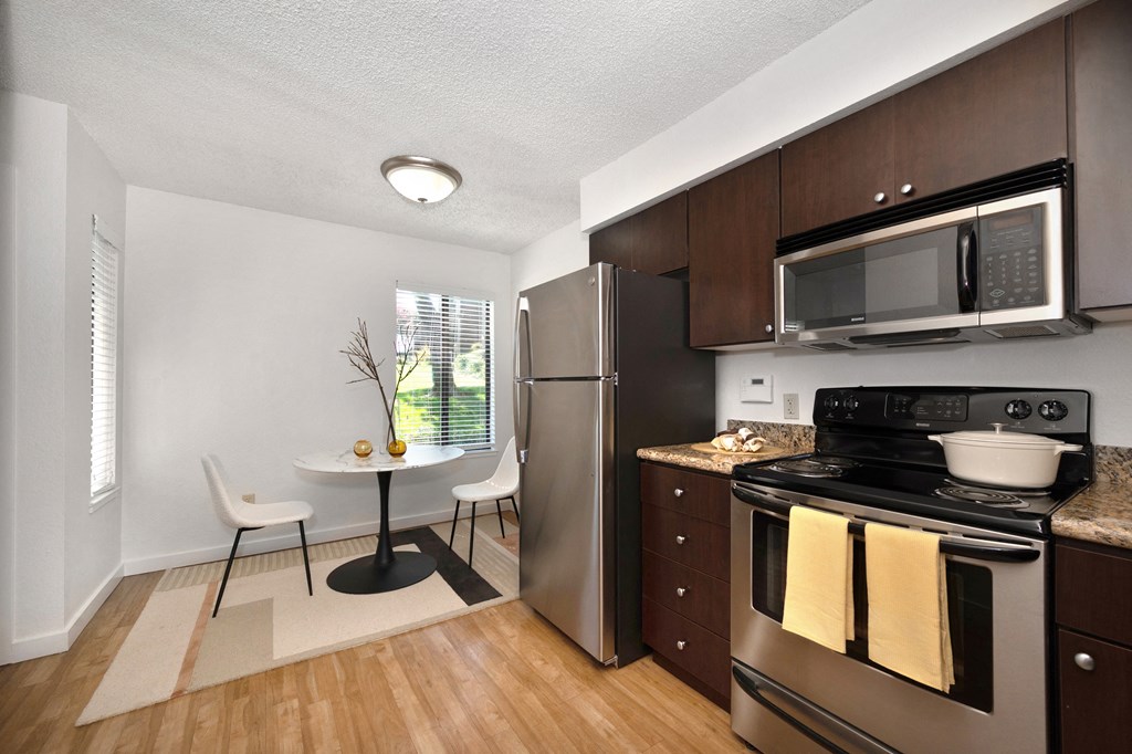 a kitchen and dining area in a 555 waverly unit at Fountains of Fair Oaks, Fair Oaks, CA