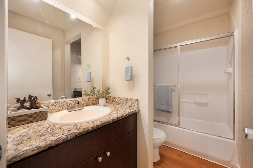 Bathroom with sink and shower with sliding shower doors at Fountains of Fair Oaks, California