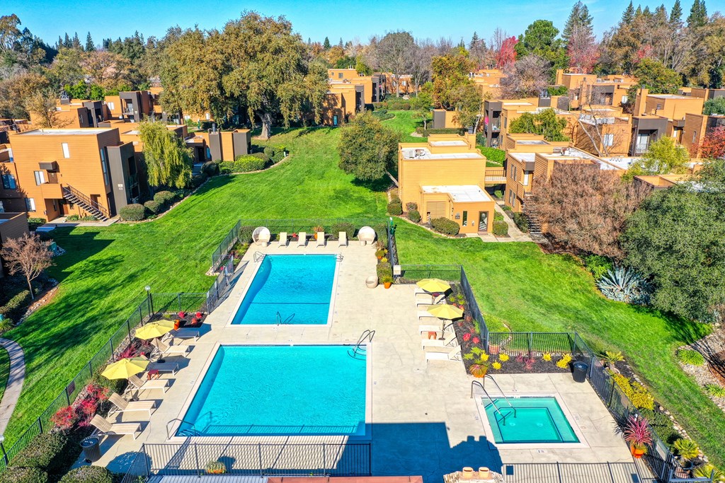 Arial view of the community with pools, spa, grassy courtyard and apartment buildings ,at Fountains of Fair Oaks, California, 95628 