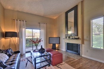 Model Apartment home with fireplace, hardwood inspired flooring and with views out the windows of the property grounds. - Photo Gallery 3