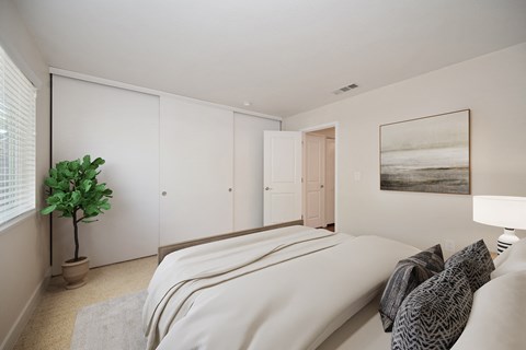 A bedroom with a large bed and huge closet with 3 closet doors at Folsom Ranch, Folsom, CA