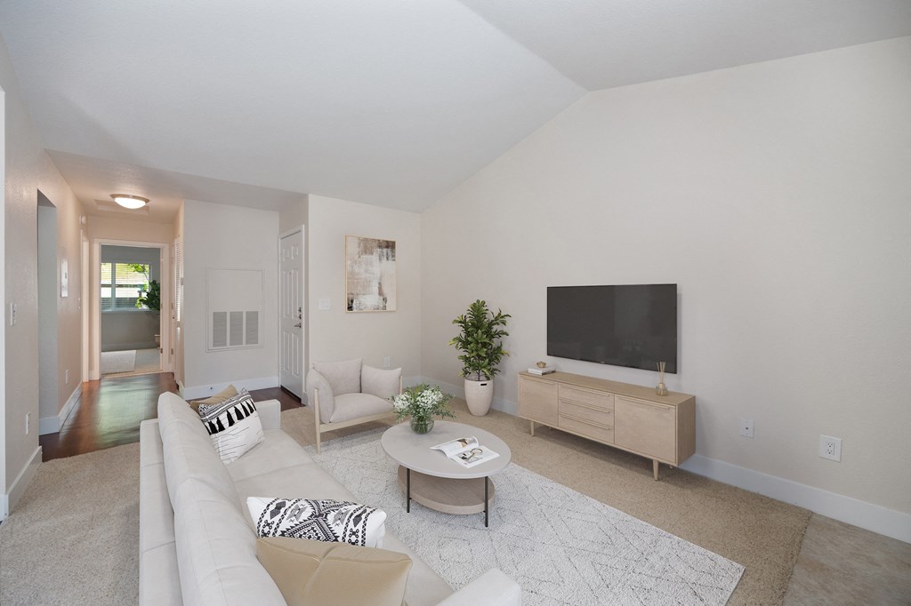 a living room with a white couch and a television at Folsom Ranch, Folsom