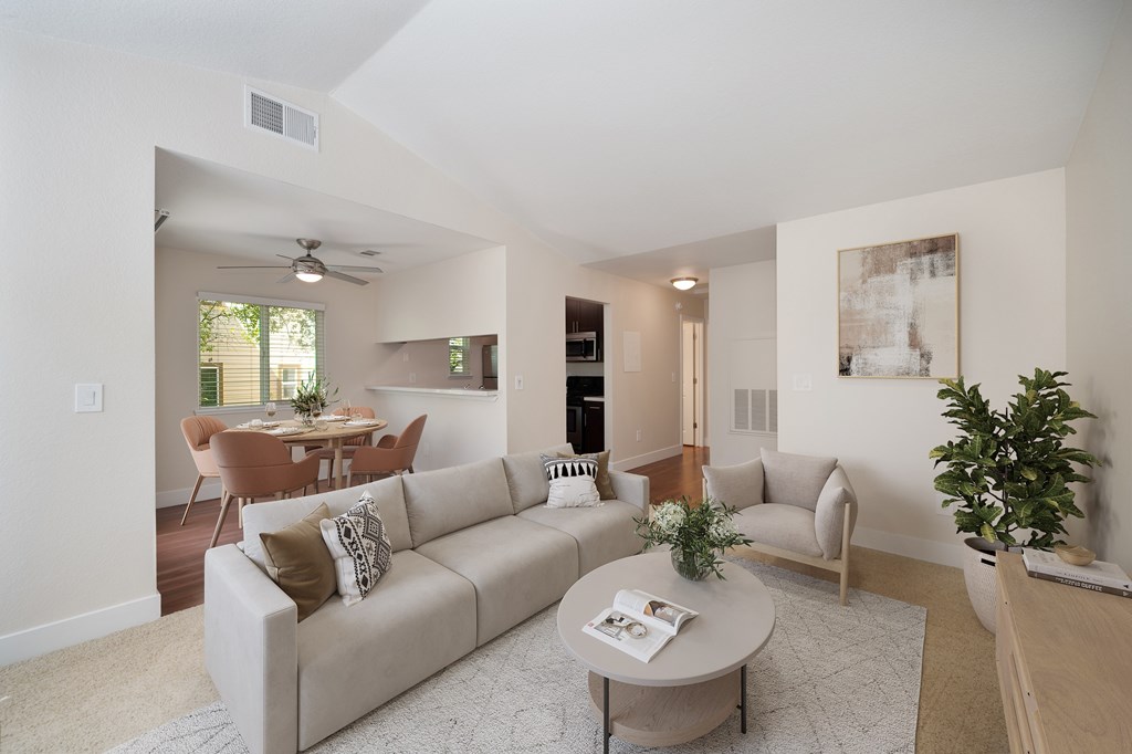 a living room with a couch and a coffee table with views of the dining room at Folsom Ranch, California