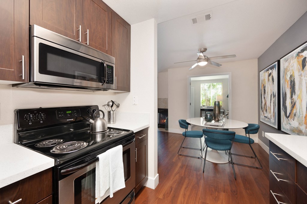 Kitchen with a stove and microwave and a dining table with chairs at Folsom Ranch, Folsom, California