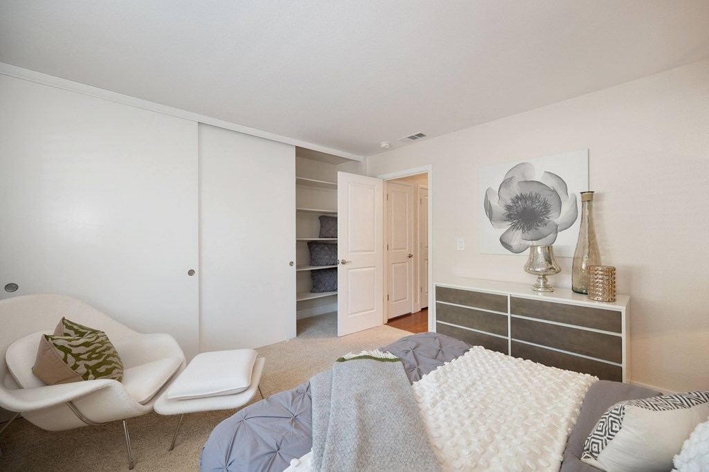 a bedroom with a bed and lounge chair at Folsom Ranch, Folsom, CA