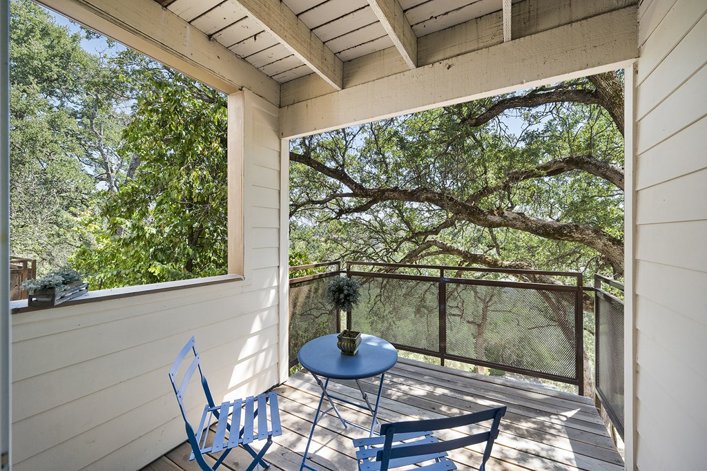 a small table and two chairs sit on a balcony with trees in the background a small table and two chairs sit on a balcony with trees in the background at Folsom Ranch, Folsom