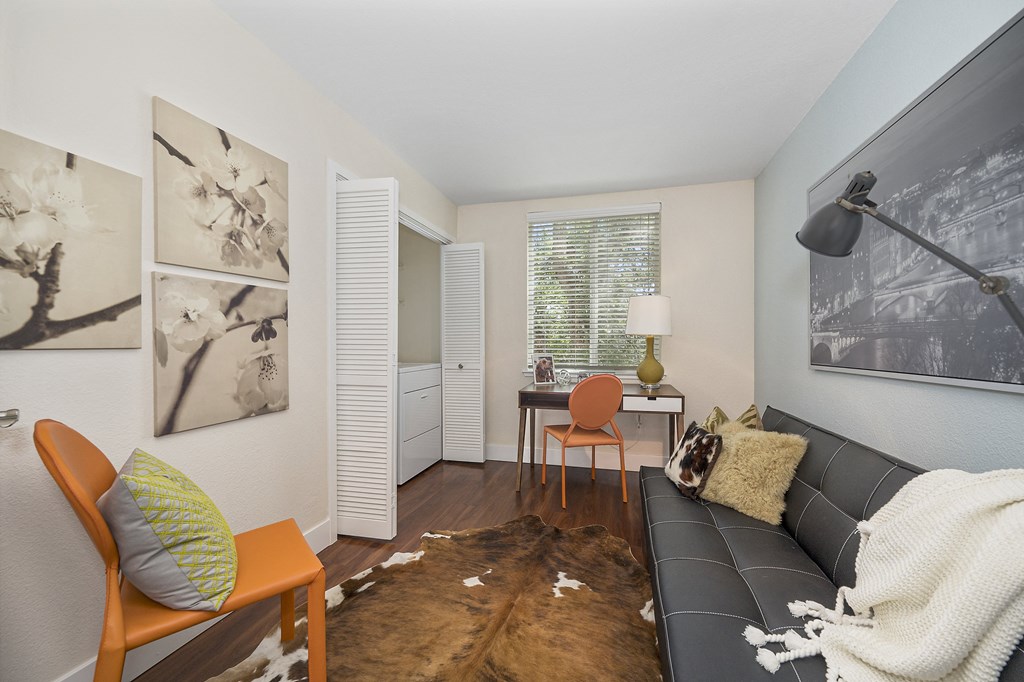 a living room with a black couch and orange chairs at Folsom Ranch, Folsom, CA