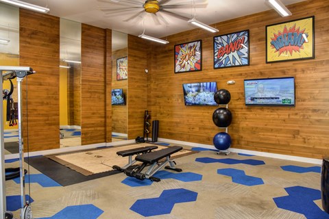 Community Fitness Center Gym with Cardio and Weight Machines, Yoga Balls and Mirrors. The walls are lined with a wooden shiplap look.at Folsom Ranch, Folsom, 95630