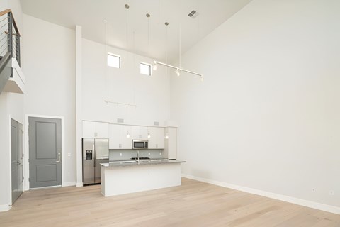A kitchen with a white counter and a fridge.