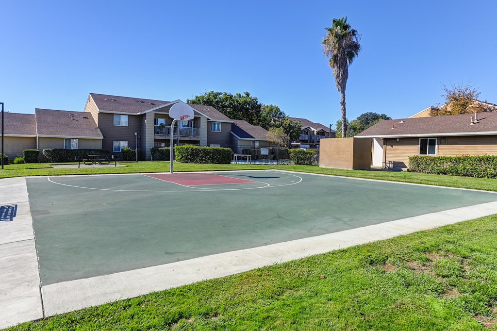 a basketball court in a neighborhood with houses