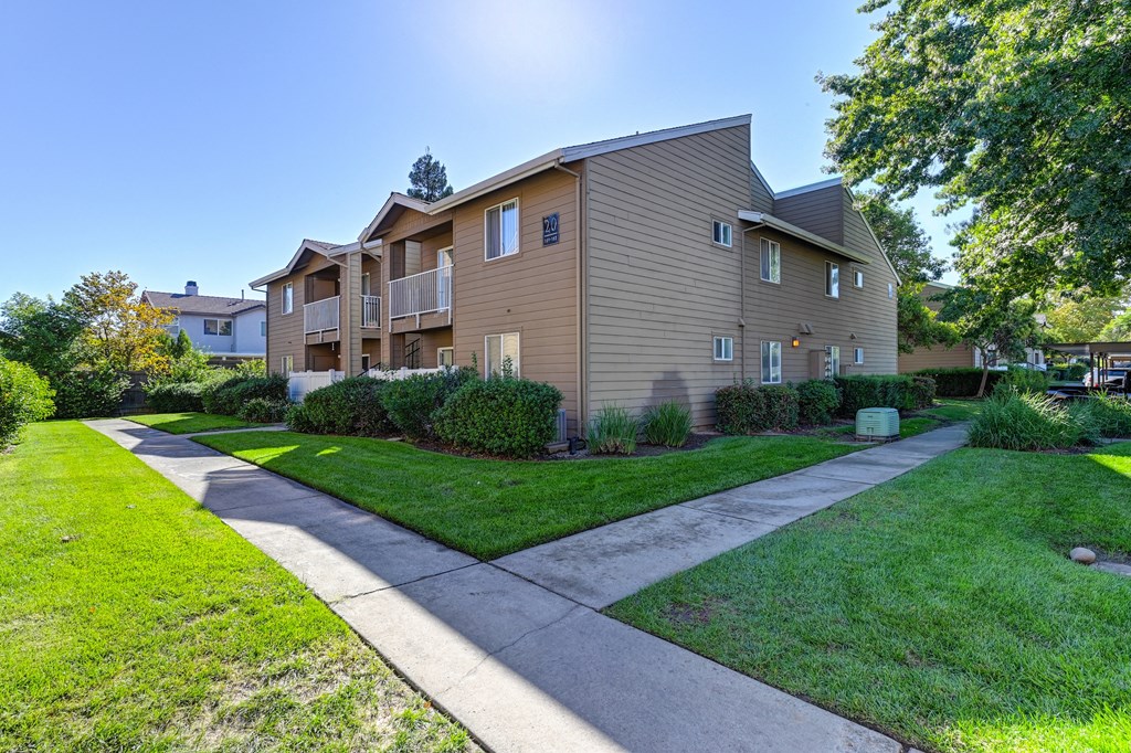 Community Exterior View of a two story apartment building at Hasting Park with a sidewalk and lawn