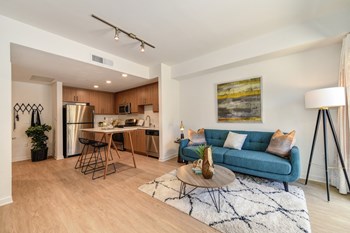 Kitchen Area Living room with hardwood inspired flooring and a view of the kitchen area - Photo Gallery 2