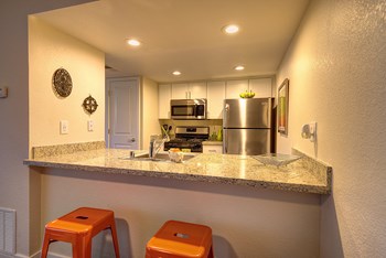 Kitchen Bar Seating Kitchen Bar Seating with Orange Stools, Granite Countertop, Sink, Refrigerator and Microwave - Photo Gallery 2