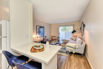 Kitchen with View of Living Room Kitchen with View of Living Room, Hardwood Inspired Floor, White Table and Blue Chairs - Photo Gallery 3