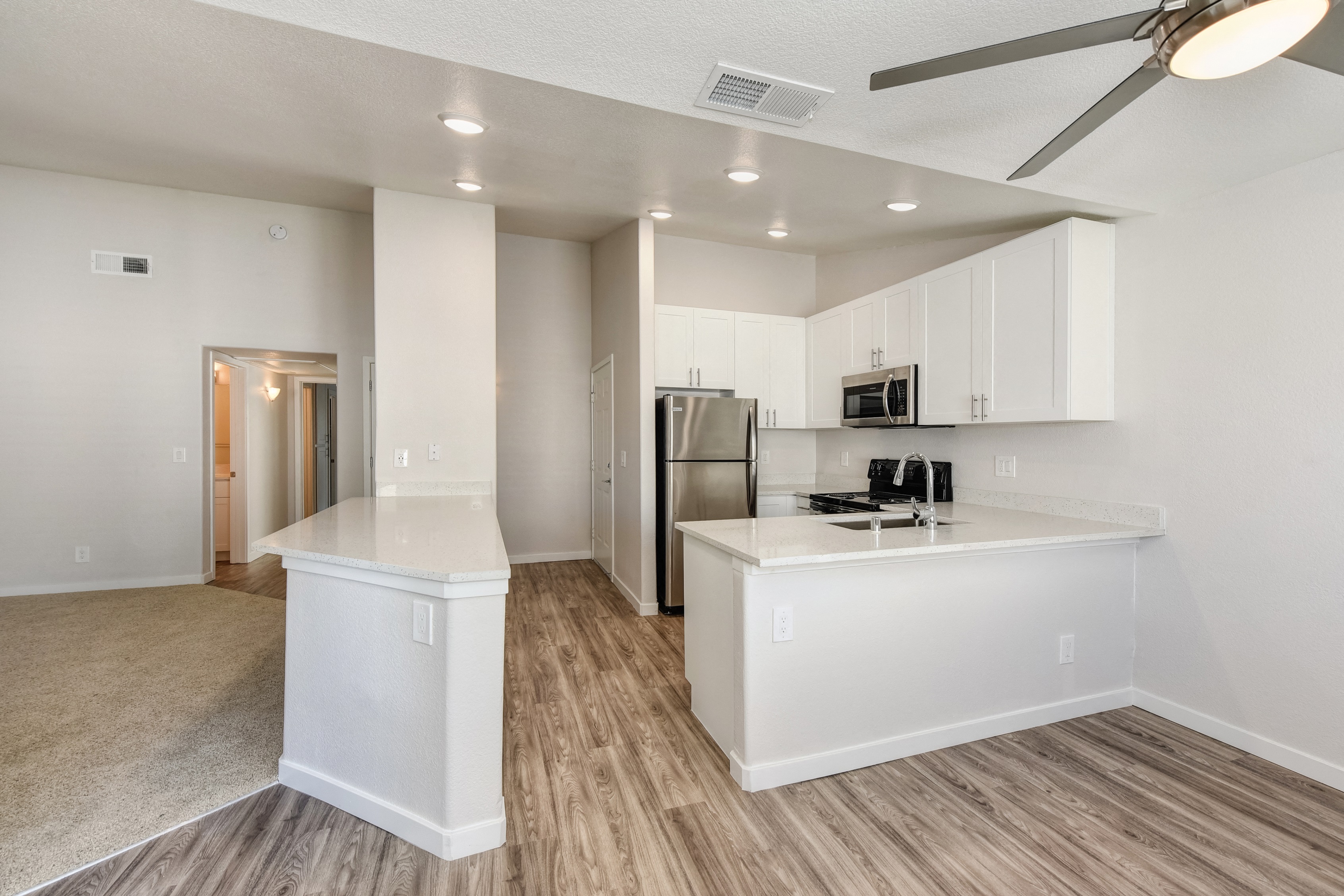 Kitchen with View of Entryway, Wood Inspired Floors, Ceiling Fan/Light and Refrigerator at The Legacy Apartments, Antelope, 95843