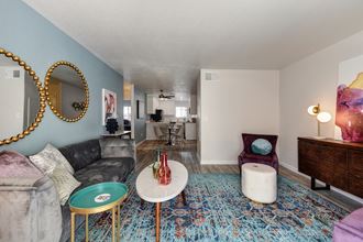 Living Room Living Room with Blue Pattern Rug, White Table, Gray Sofa, Purple Chair and Round Wall Mirrors - Photo Gallery
